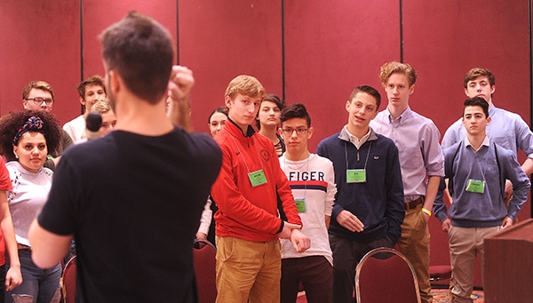 Area Catholic students listen as Adam Jarosz, director of youth and Young Adult Ministry St. Gregory the Great, hosts the 